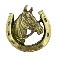 a horse head is mounted on the side of a brass plated broochle