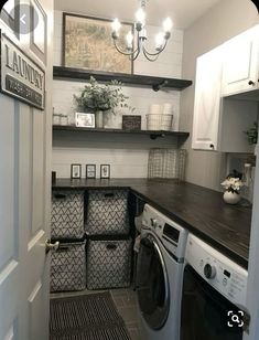 a washer and dryer in a small room with shelves above the washer