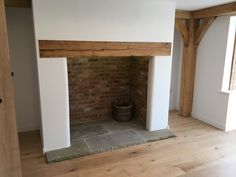 an empty room with a brick fireplace in it