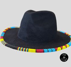 Native American beaded fedora in blue, red, yellow and black beads. Hundreds of size 11 beads rim this hat in a geometric pattern. Desire your own color combination? Reach out for a custom piece. Multicolor Curved Brim Fedora For Festivals, Artisan Multicolor Brimmed Fedora, Handmade Multicolor Flat Brim Fedora, Multicolor Beaded Hat With Curved Brim, Black Beaded Hat Bands For Beach, Handmade Multicolor Brimmed Fedora, Black Beaded Hat Band For Beach, Traditional Multicolor Fedora Hat, Multicolor Beaded Brimmed Hat