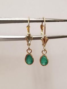 "Thanks for shopping our vintage estate store. We tend to sell well below wholesale and truly hope you enjoy all of our items. Many of the items are one of a kind, so please enjoy scrolling through the pictures and hopefully something will catch your eye. Brown spots are from camera or reflections. Nice estate 14k yellow gold natural .50ct emerald tear drop lever back earrings.  Length: 7/8\" Width: 1/4\" 4.5mm Weight: .92 gram Gem: 6mm by 4mm Beautiful earrings, marked 14k." Classic Teardrop May Birthstone Earrings, Classic Teardrop Earrings For May Birthstone, Classic Lever Back Jewelry For Anniversary, Classic Pear-shaped May Birthstone Earrings, Classic Teardrop Lever Back Jewelry, Teardrop Lever Back Jewelry For Anniversary, Brown Spots, Tear Drop, Beautiful Earrings