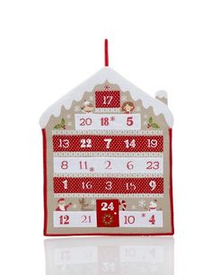 a red and white house shaped ornament with the numbers twenty five on it