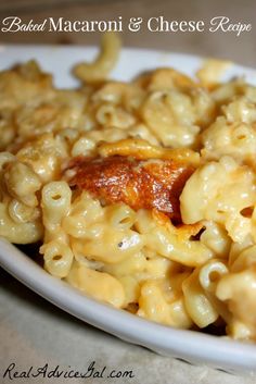 macaroni and cheese with meat in a white bowl on a wooden table top