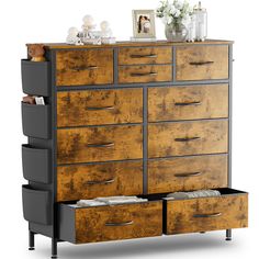 an old dresser with drawers and pictures on top