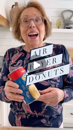 an older woman holding up two signs that say air layer donuts and peanut butter