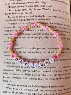 a pink beaded bracelet with the words daughter written on it