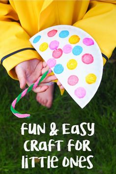 a child holding a paper kite with the words fun and easy craft for little ones