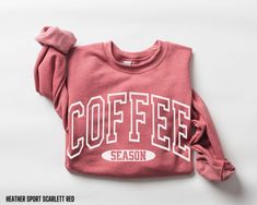 You will love this minimalist coffee season sweatshirt.  It comes in 4 beautiful colors, dark heather grey, military green, heather sport scarlet red, and sand. This cozy crewneck sweatshirt has block font graphic on the front that says coffee season. This will make a great gift for that coffee lover, or for yourself.  It will be the perfect crewneck sweatshirt for any woman to wear in the fall and winter seasons. Sweatshirt Details: *50% cotton, 50% polyester *Medium-heavy fabric (8.0 oz/yd² (2 Sporty Heather Sweatshirt For Fall, Cute Sweatshirts, Oversized Sweatshirt, Fall Sweaters, Coffee Lover Gifts, Hoodie Top, Unisex Shirt, Coffee Lover, Everyday Fashion