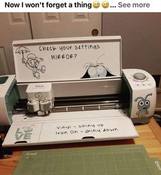 a machine that is sitting on top of a table next to a cutting board with writing on it