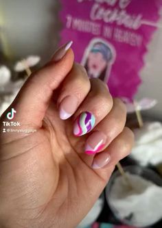 a woman's hand with pink and white nail polish