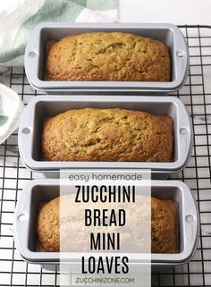 three loafs of zucchini bread sitting on top of a cooling rack