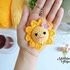 a crocheted lion keychain is shown in the palm of a person's hand