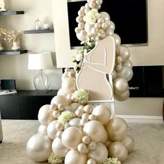 an arrangement of balloons and flowers in a living room