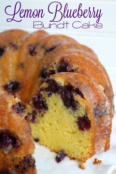 a lemon blueberry bundt cake is cut in half and on a white plate