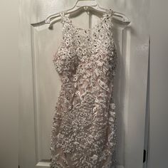 Jovani Dress. Perfect For An Engagement Party. Worn Once. Cups Are Sewn In Already. A Little Of Makeup Stains On The Inside. As Shown In The Picture. Size 8 But Taken In To Fit Like A 6! Elegant White Sequin Dress For Prom, Elegant Floral Embellished Mini Dress For Prom, Sleeveless Embellished Sequin Lace Dress, Embellished Sleeveless Sequin Lace Dress, Party Dresses In Lace With Pearl Embroidery, Lace Dresses With Pearl Embroidery For Party, White Embellished Sleeveless Evening Dress, Embellished Sleeveless Mini Dress For Wedding, White Embellished Sequin Dress For Prom