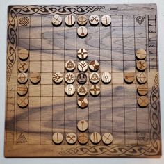 a wooden board game set up on top of a white wall with lots of buttons