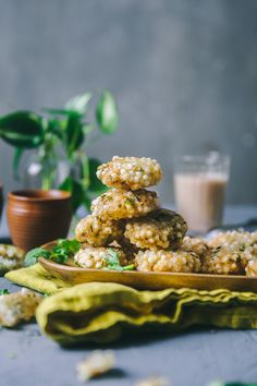 a stack of cookies sitting on top of a plate next to a glass of milk