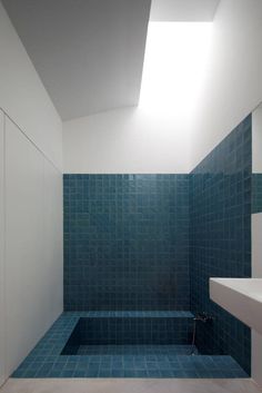 a black and white photo of a bathroom with a skylight above the bathtub