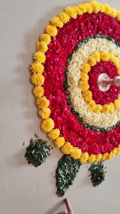 a large flower arrangement is hanging on the wall