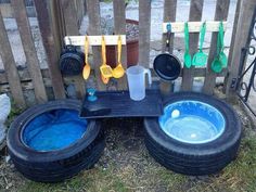 there are two tires that have been placed next to each other on the ground with spoons in them