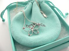 Overview:Do you know which items made Tiffany a world renowned company? You just stumbled upon one of them! Offered for sale is a wonderful and very rare Tiffany and Co. Sterling Silver and Pink Sapphires Butterfly necklace. The necklace is made from solid and substantial Tiffany silver, yet has a very delicate and feminine feel to it. Hanging from its substantial and bright Tiffany Sterling Silver curb chain is beautiful Butterfly pendant accented with 7 bright and sparkly Pink Sapphire gemston Designer Polished Finish Necklace Gift, Designer Sterling Silver Necklace Gift, Designer Sterling Silver Necklace For Gift, Designer Engraved Necklace For Gift, Luxury Necklaces For Gifts, Designer Pendant Jewelry As A Gift, Luxury Hallmarked Pendant Jewelry, Designer Red Jewelry As Gift, Designer Red Jewelry For Gift