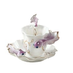 three cups and saucers with unicorns on them