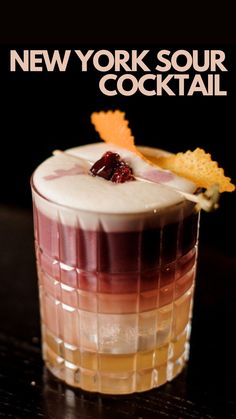 the new york sour cocktail is garnished with cranberries and orange peels