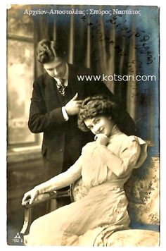 an old black and white photo of a woman sitting in a chair next to a man