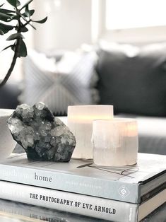 a couple of books sitting on top of a table next to a vase filled with flowers