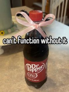 a bottle with a pink ribbon on it that says can't function without it