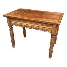 an old wooden table with turned legs and carved wood decoration on the top, isolated against a white background