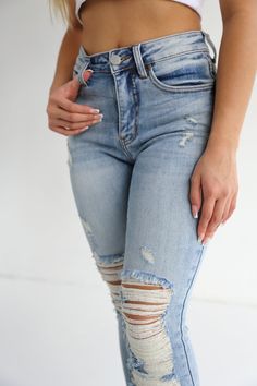 Our Dominique jeans are one of our favorite skinny, and will be yours too! These figure-hugging, medium wash, distressed jeans are perfect for everyday wear! Pair these with a trendy top and transparent heel for a complete look! MODEL MEASUREMENTS: Model is wearing a size 1 Height: 5'0 Rise: 9.75" Inseam: 27.5" *True to size for most* MATERIAL: 95% COTTON, 3.5% RAYON, 1.5% SPANDEX Transparent Heels, Trendy Top, Trendy Tops, Model Measurements, Distressed Jeans, Mid Rise, Everyday Wear, Spandex, Heels