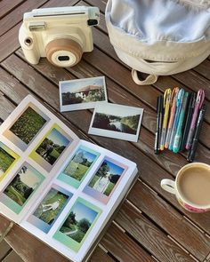 an open book sitting on top of a wooden table next to a cup of coffee