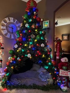 a decorated christmas tree in the corner of a living room with lights on and around it