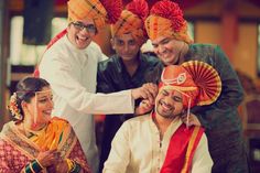 a group of people standing around each other wearing headgear on their foreheads