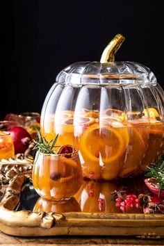 there is a glass bowl filled with oranges