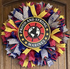 a wreath with the words proud and strong marine on it is hanging on a door