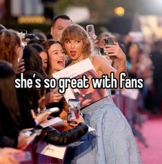 a woman taking a selfie with her friends on the red carpet at an event