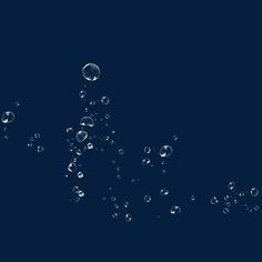 water bubbles floating in the air on a dark blue background