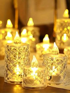 several lit candles sitting on top of a table