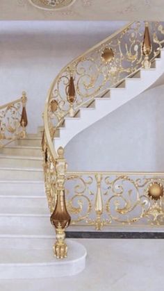 a white and gold staircase in a house