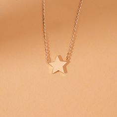 Capella A night sky’s dream. Add a touch of celestial magic to your everyday style with this dainty Mini Star Necklace, crafted entirely in solid gold. This dainty piece features a tiny, gleaming star pendant suspended on a shimmering chain, catching the light with every movement. Wear it on its own for a whisper of understated elegance or layer it with other necklaces for a bolder, personalized look. - Handmade- Solid Gold- Star Size: 8 mm All pieces come beautifully boxed in suede pouches you can always use when traveling! Minimalist Yellow Gold Jewelry With Star Charm, Delicate 14k Gold Jewelry With Star Charm, Minimalist Rose Gold Star Charm Jewelry, Elegant 14k Gold Filled Necklace With Star Charm, Elegant 14k Gold-filled Necklace With Star Charm, 14k Rose Gold Jewelry With Star Charm, Rose Gold 14k Gold Star Jewelry, Delicate Yellow Gold Star Jewelry, Elegant Rose Gold Star Necklace