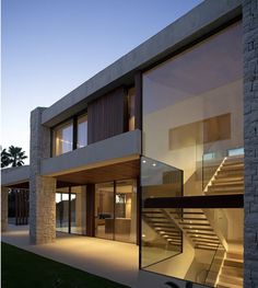 an exterior view of a modern home with stairs leading to the upper floor and second story