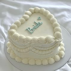 there is a white cake with frosting on the top that says, happy birthday