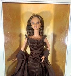 the doll is wearing a brown dress