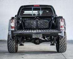 the back end of a truck with tires on it