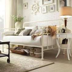 a living room filled with furniture and a white table in front of a large window