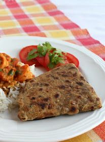 a white plate topped with rice and veggies next to a tortilla