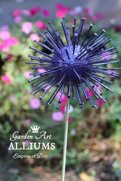 a close up of a purple flower with the words garden art alliums on it