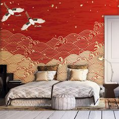 two birds flying over a bed in a room with red wallpaper and white flooring